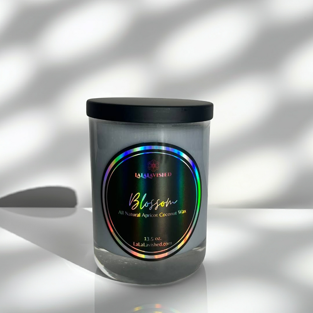 Candle jar with a colorful label on a reflective surface