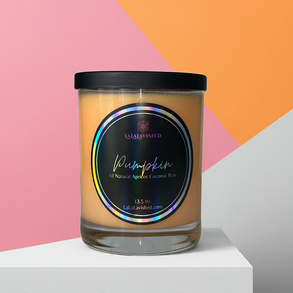 Pumpkin Candle with a colorful label on a geometric pink and orange background