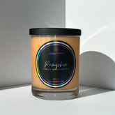 Pumpkin Candle with a colorful label on a white surface
