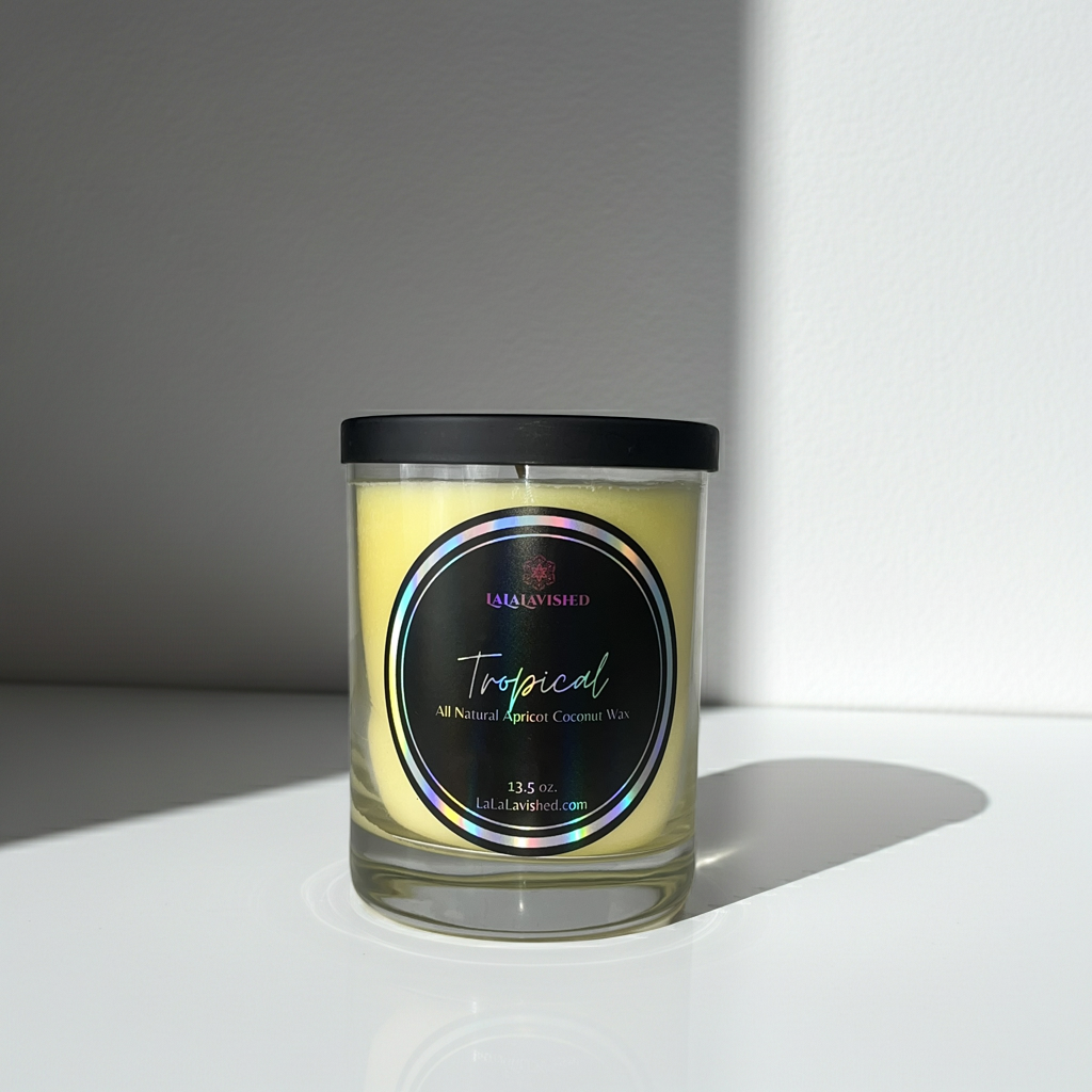 Candle in a glass jar with a black lid on a white surface